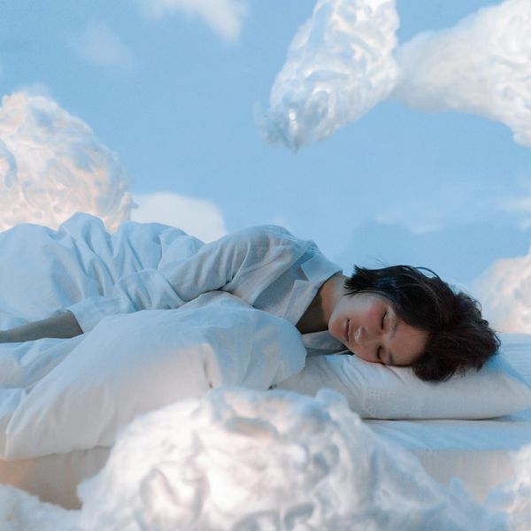 Person in a calm, meditative pose, symbolizing relaxation and sleep.