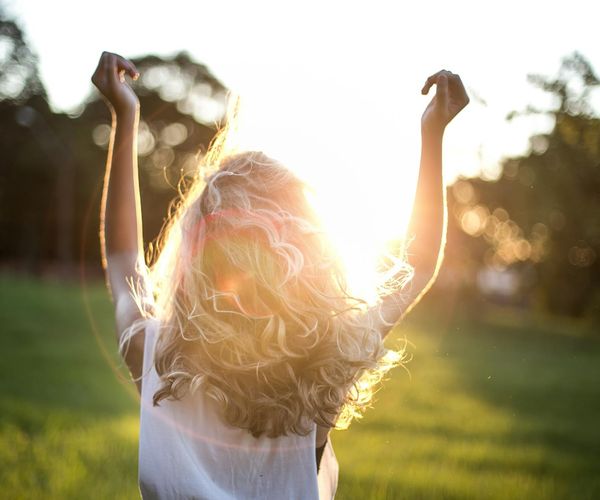 Sun rising over mountains, symbolizing renewed energy and well-being.